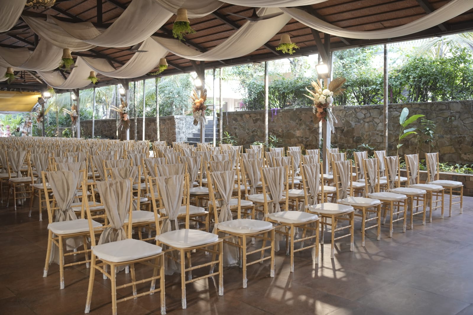 Draped chiavari chair ceremony setup with pampas florals