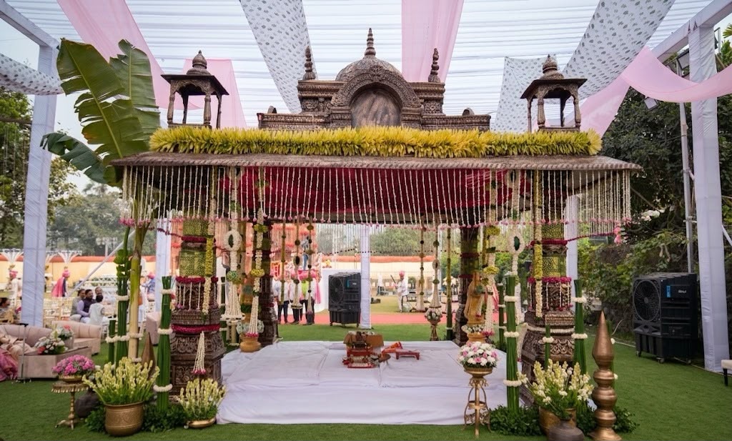 Traditional carved mandap with floral drapes and jasmine curtains